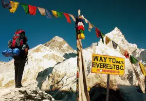 Evening View of Everest with Hiker and Buddhist Prayer Flags from Kala Patthar